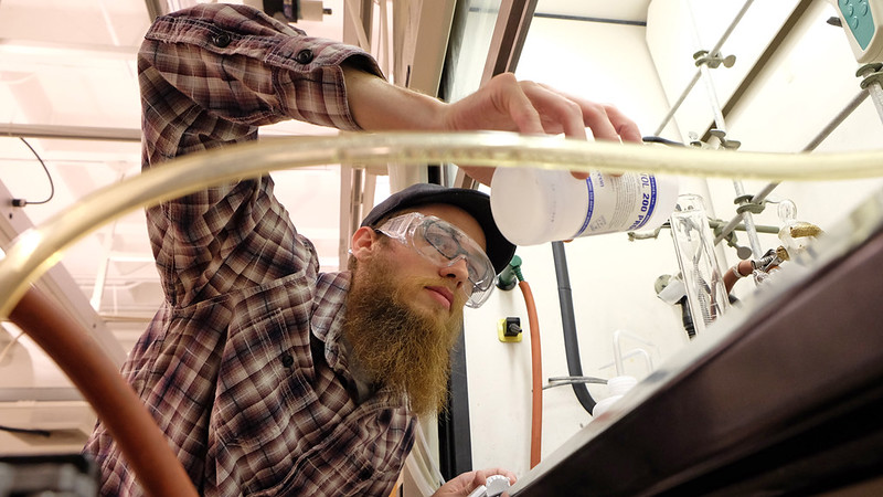 escription-Henry Hamper, an undergraduate research grant recipient at UMSL, makes nanoporous carbons in Benton Hall. His work in the lab is aimed at improving lithium batteries and hydrogen-powered vehicles. (Photo by August Jennewein)
