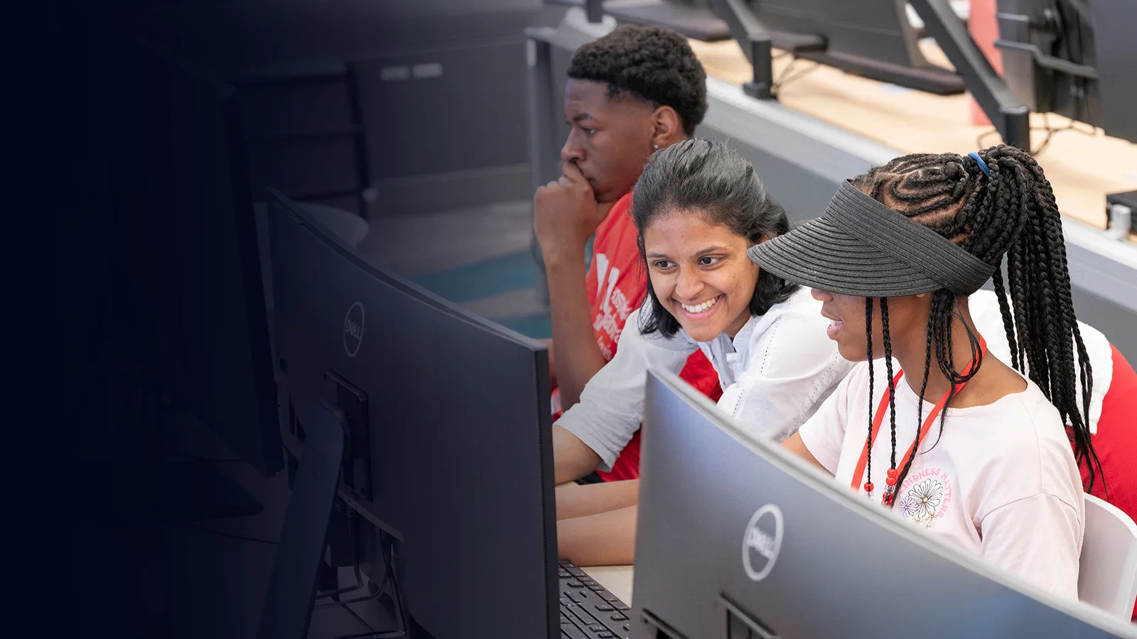 Smiling instructor and student looking at computer