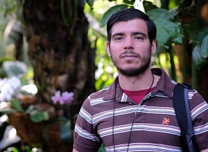 international student in front of plants