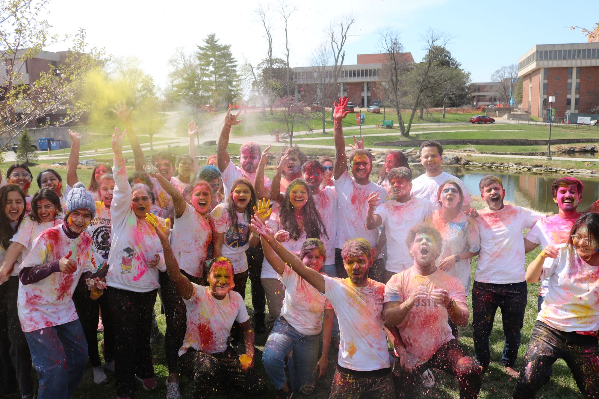 Students posing for a picture covered in Holi powder