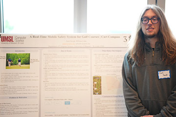 Displays a photo of the 2nd place non-thesis winner standing next to their poster.