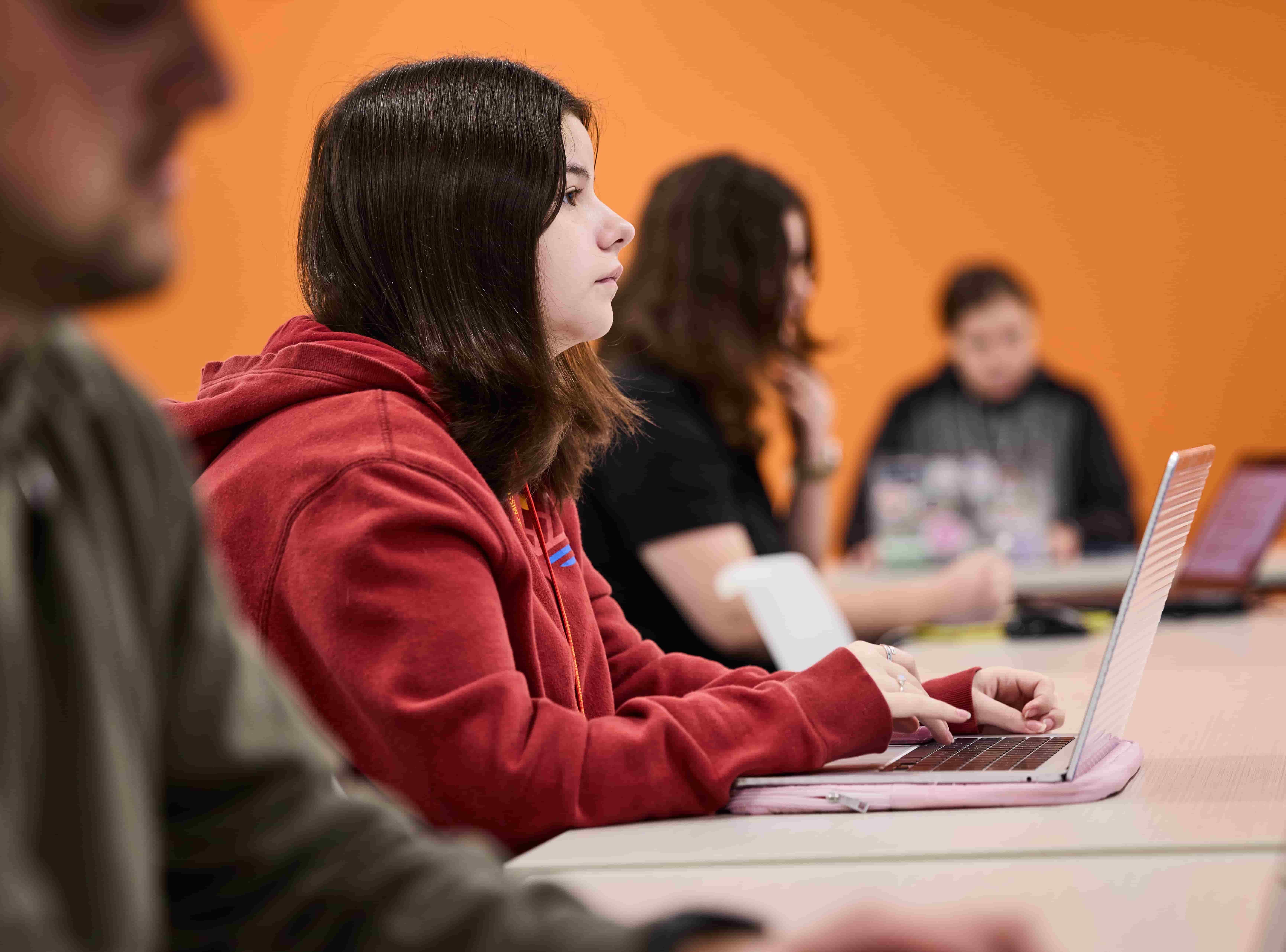 A row of students seated in a classroom