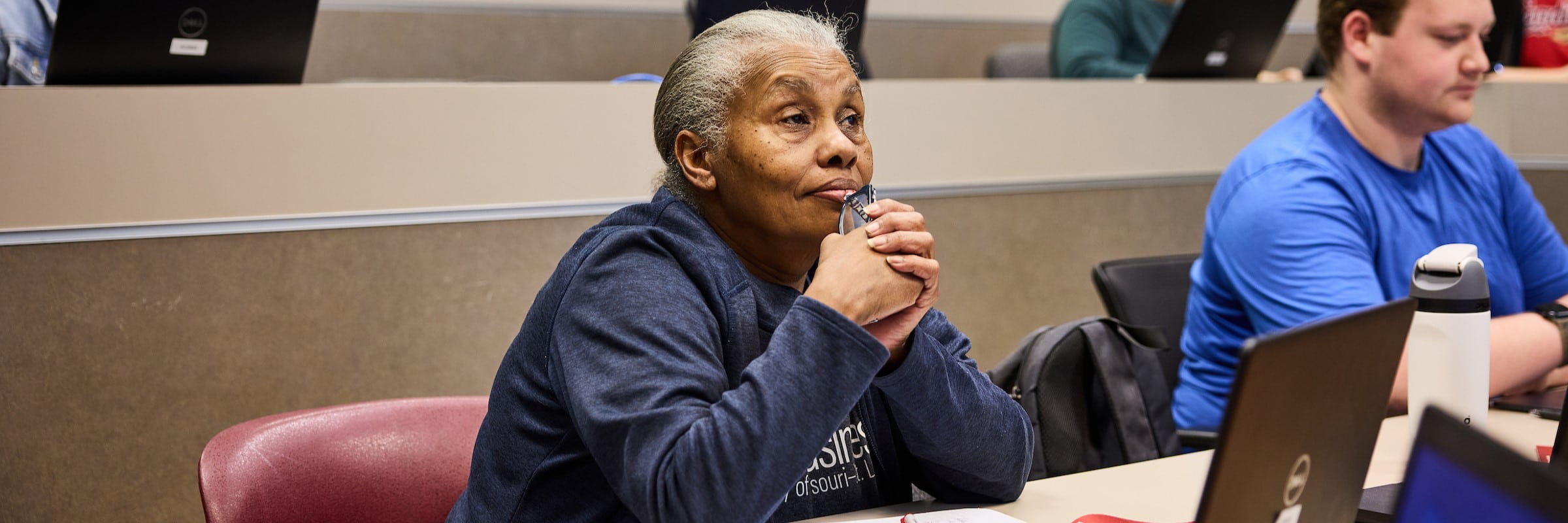 An adult student listens attentively during a lecture