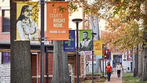branded pole banners along a sidewalk on south campus