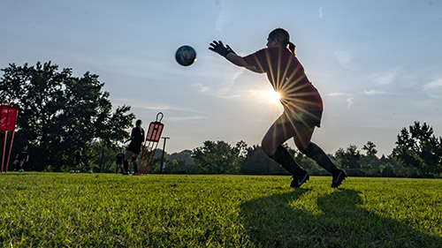 soccer goalie with a sunflare during early morning practice