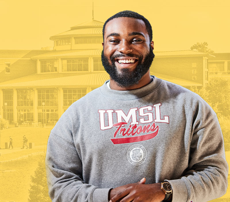student smiling wearing UMSL sweatshirt