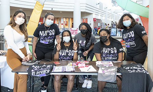 A group of minority nurses at a student booth