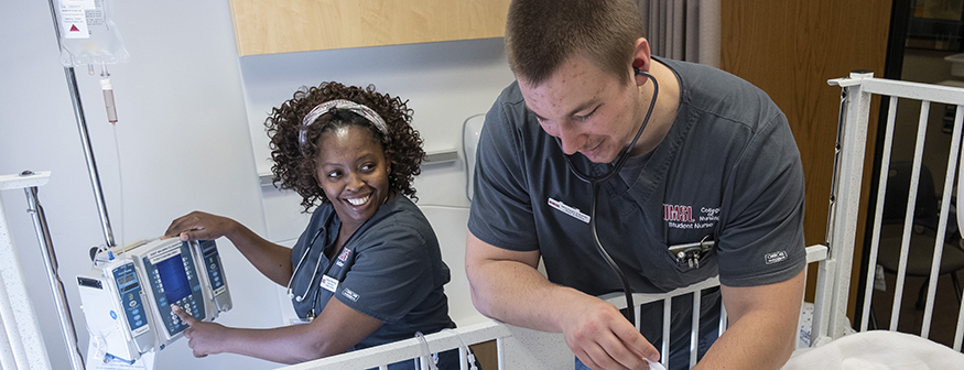 two nursing students in the simulation lab