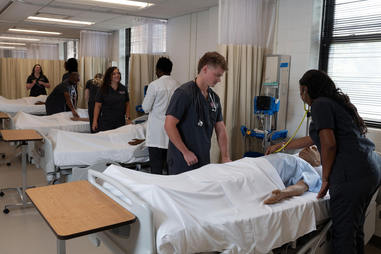 student and a professor in the simulation lab