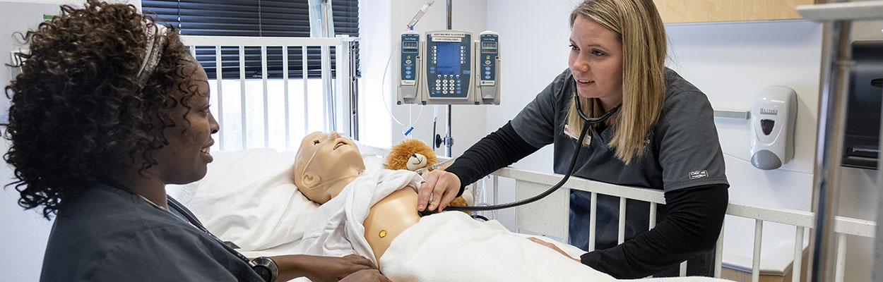 2 nursing students in a simulation lab