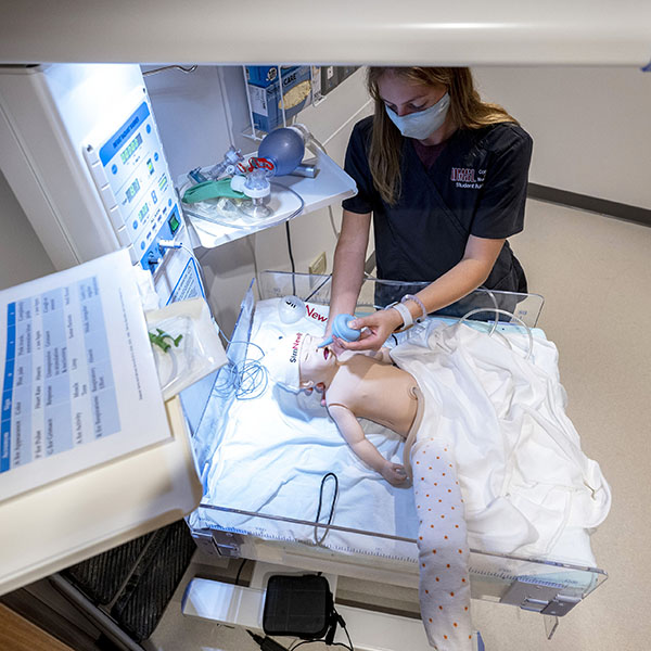 nursing student with baby simulation patient