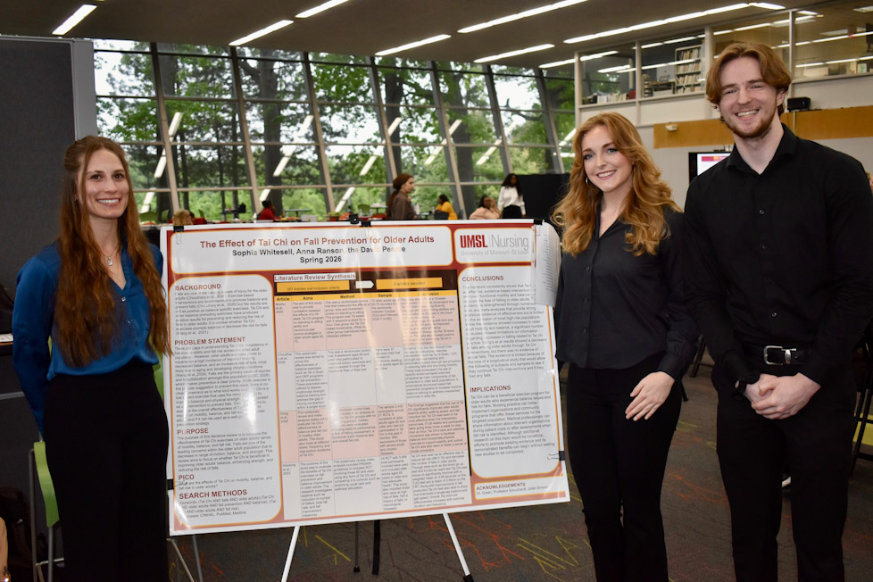 Three students stand beside a research poster on the effect of tai chi on fall prevention for older adults at a campus poster session.