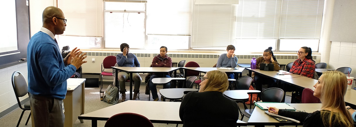 students at tables in a classroom