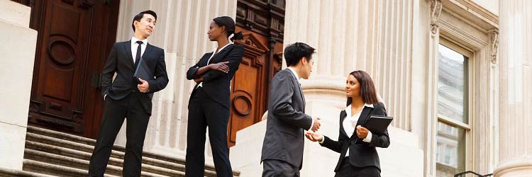 4 people on the stairs of a government building