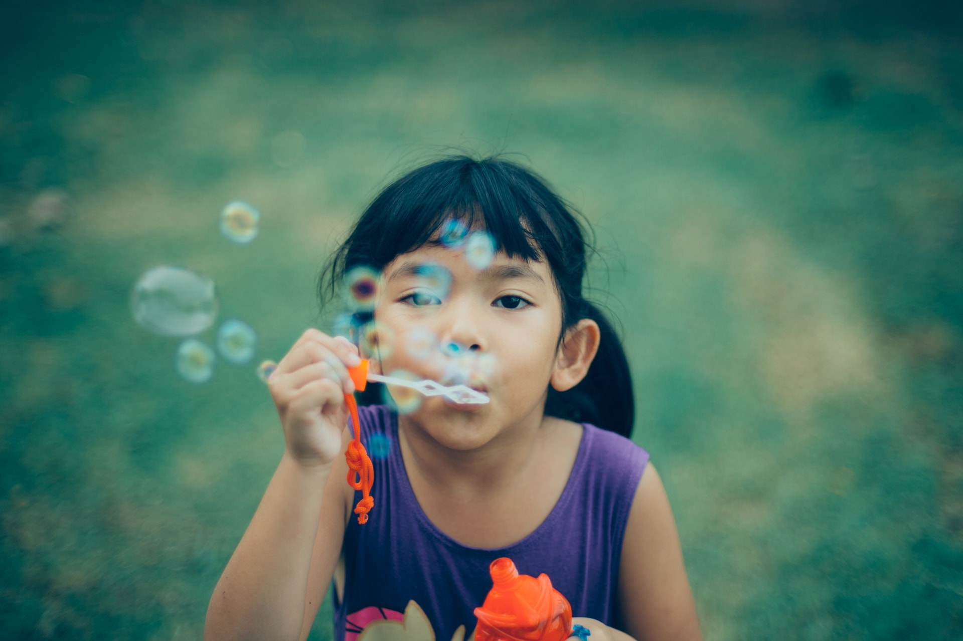 Little girl blowing bubbles