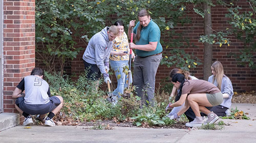 students doing yard work