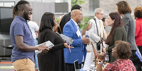 people talking at a community job fair