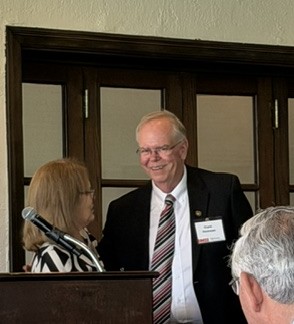 Connie turns over the gavel to Clark Hickman