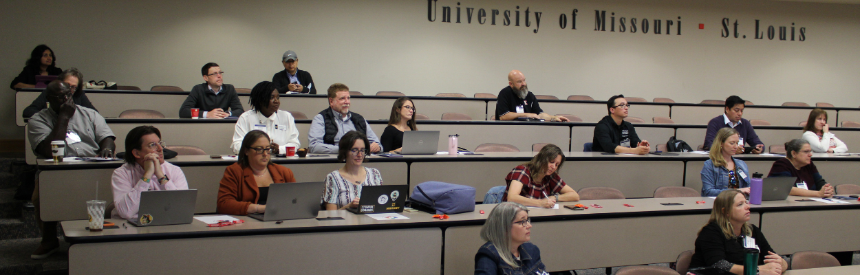 A group of people sitting in a lecture hall