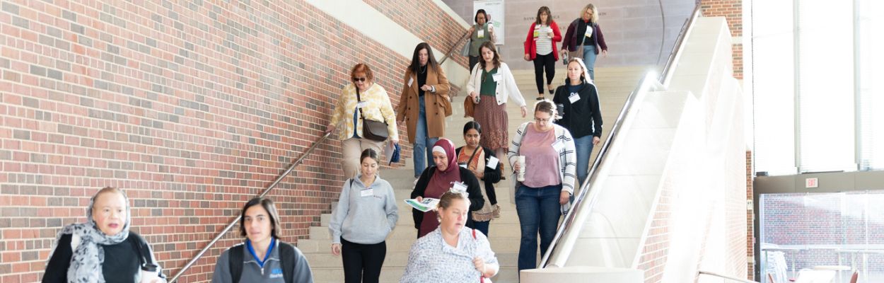 A large group of people walking down a set of stairs