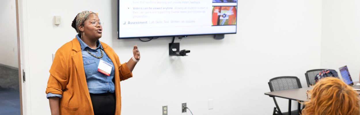 A woman in business casual attire speaking 