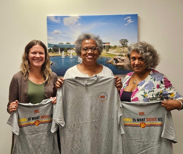 Research Trackers are holding Triton Walking Club shirts after winning the team prize.