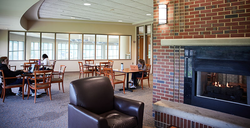 fireside lounge fireplace and students at tables