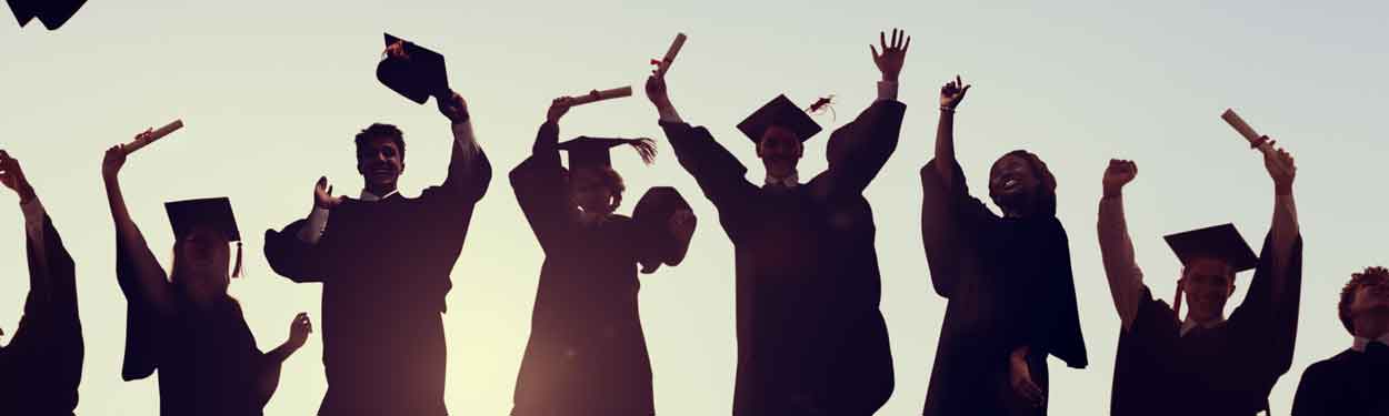 silhouettes of graduates with graduation caps