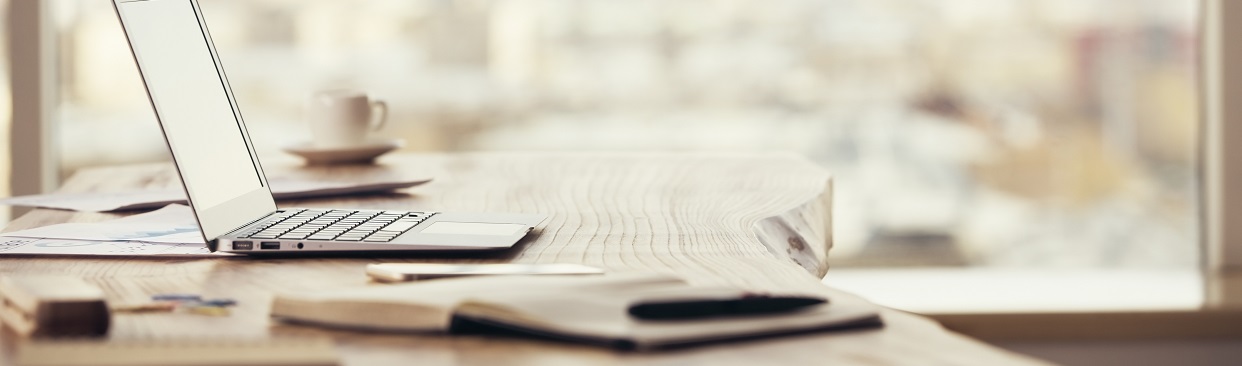 open laptop and coffee mug on table