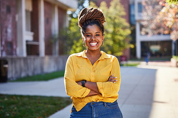 UMSL student smiling at the camera on campus