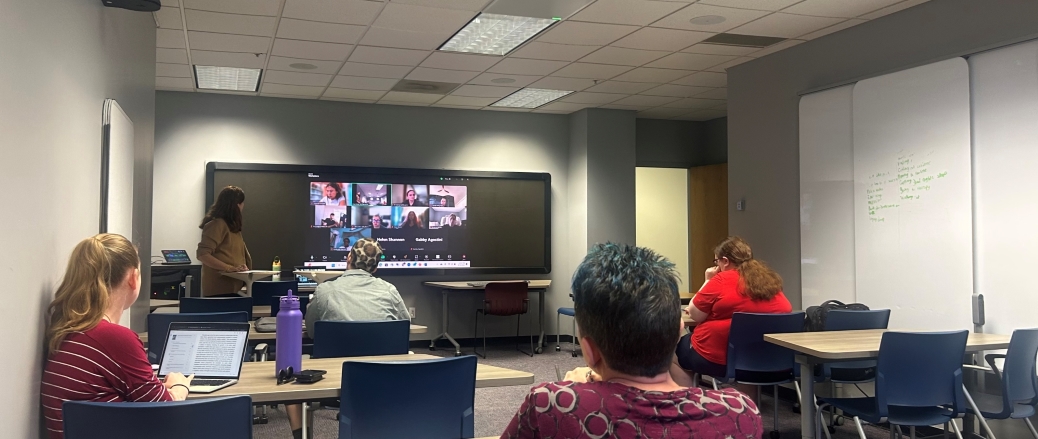 Picture of a Live/Virtual classroom being presented by Professor McDermott, with in-person students and virtual students present in the picture