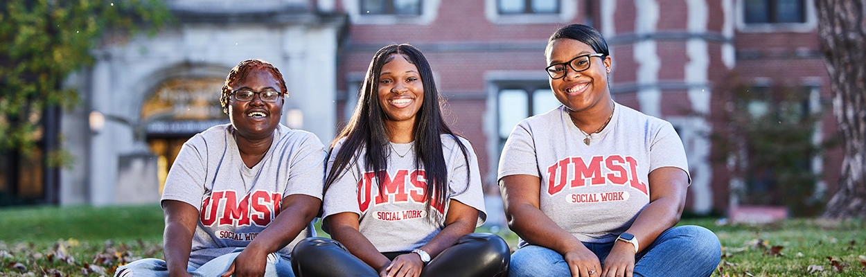 three social work students sitting outside on campus