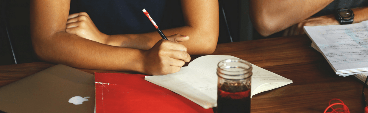 Person using a pencil to take notes. Banner for the Undergraduate Advising Office