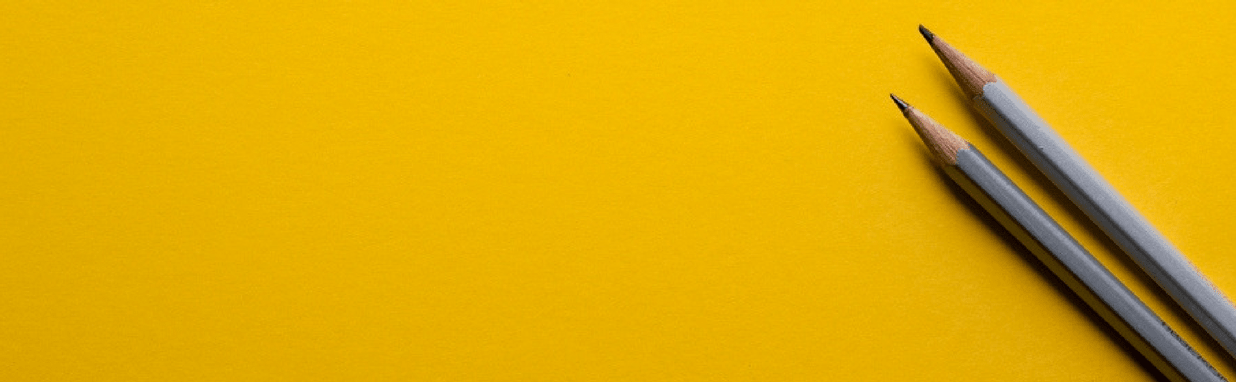 two pencils on a gold background