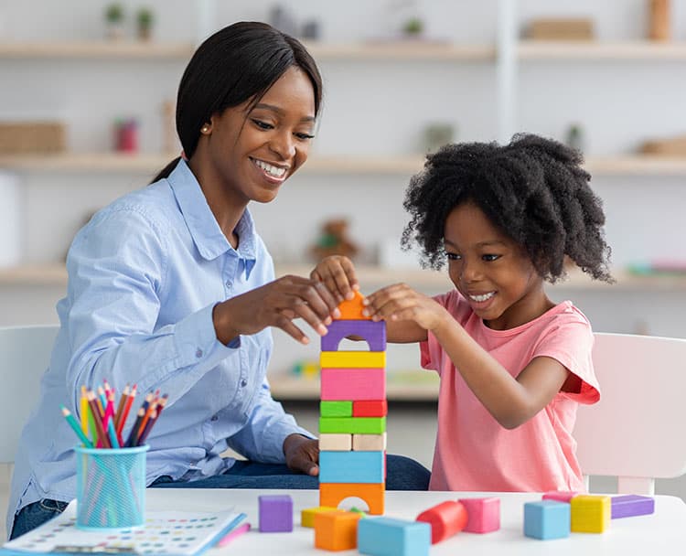 therapist playing with blocks with a child