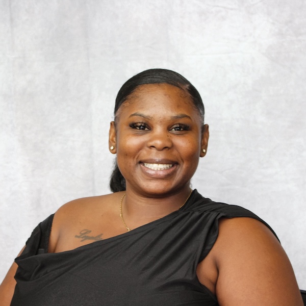 Smiling professional headshot of a woman with shoulder-length gray-blonde hair wearing a dark blazer.