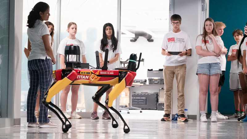 students and umsl's robotic dog, titan
