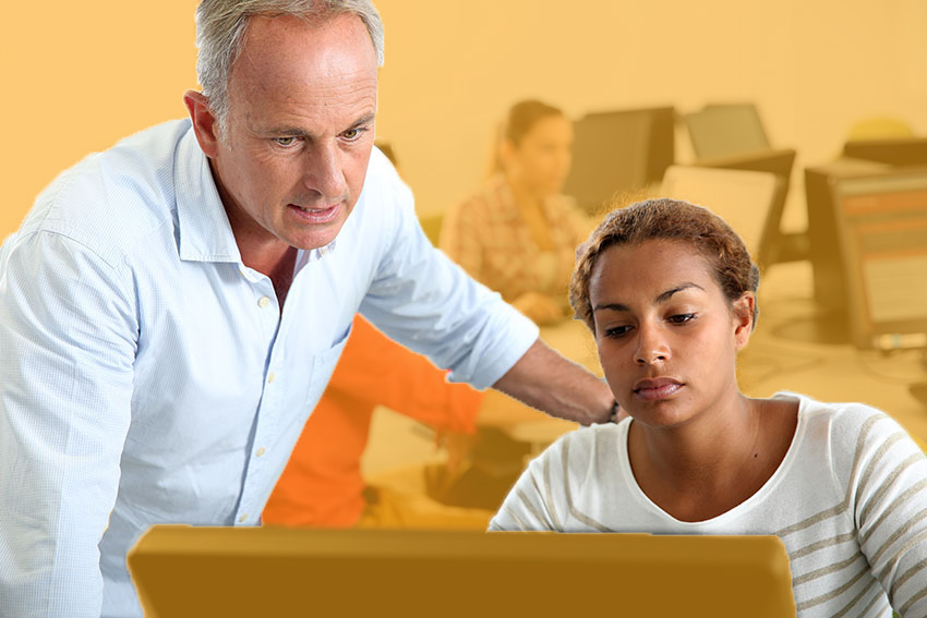 student and teacher in computer lab