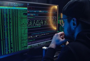 Student looking at code on the computer to understand cybersecurity via SQL 