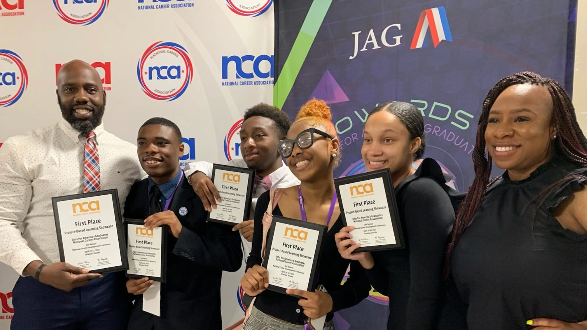 JAG students holding first place awards