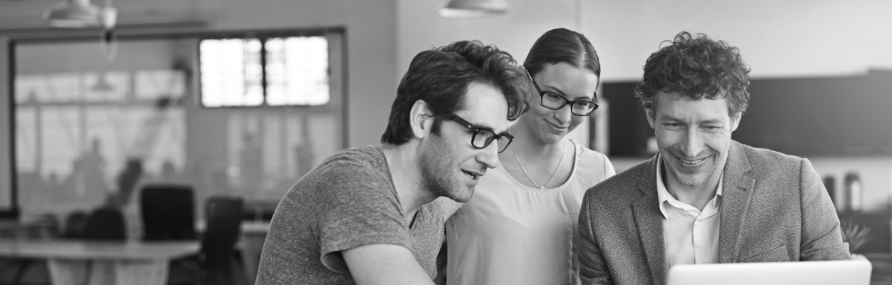 three workers at comptuer