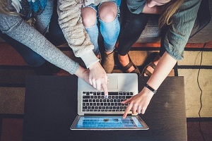 person pointing at computer screen