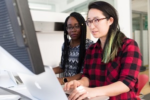 Person taking notes from computer