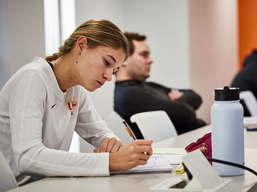 student in class writing